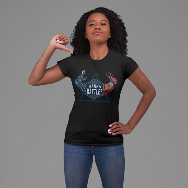 Women t-shirt wanna battle black and a woman pointing at her t-shirt in an empty studio background